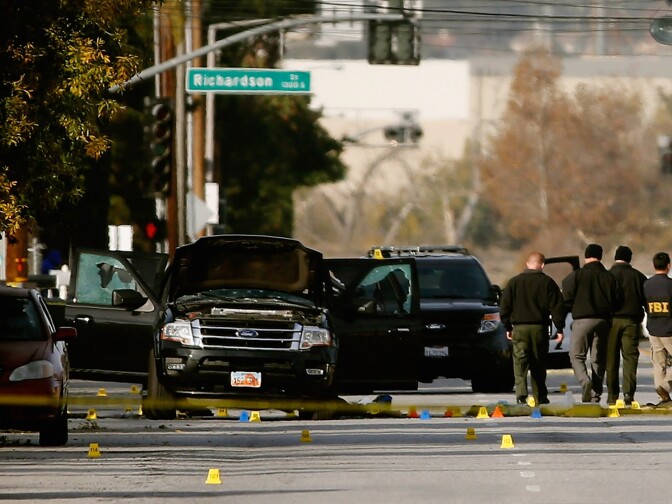 FBI agents and local law enforcement examine the crime scene where suspects of the Inland Regional Center were killed on December 3, 2015 in San Bernardino, California.
