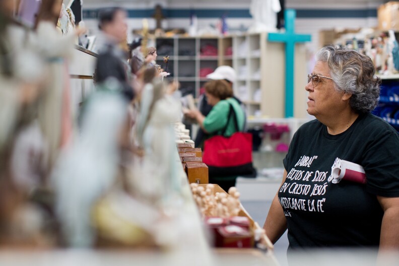 A customer shops at Cotter Church Supplies Inc. on Wednesday March 12, 2014. About 60 percent of the store's business comes from churches, with 40 percent coming from laity.