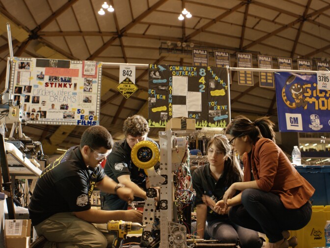 Engineer Angelica Hernandez mentors students from her former Phoenix high school as they prepare to enter a robotics contest.
