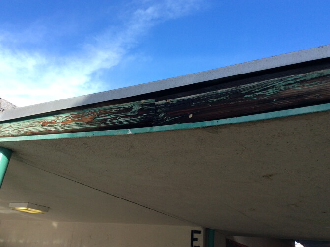 An inspector's photo shows a breezeway outside a classroom "falling in."