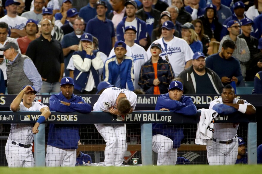 The Los Angeles Dodgers watch the ninth inning from the top step against the Houston Astros in game seven of the 2017 World Series at Dodger Stadium on Nov. 1, 2017.