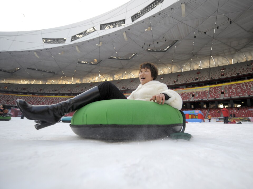 A woman goes snow-tubing in January 2010 inside the Bird's Nest, which was transformed temporarily into a winter theme park.