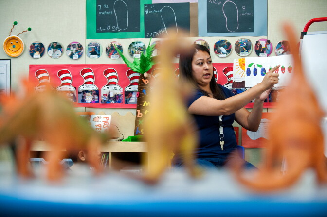 Teacher Alma Becerra reads "The Very Hungry Caterpillar" to preschoolers. The Head Start program prepares kids for kindergarten in math, language, motor movement and building self-esteem.