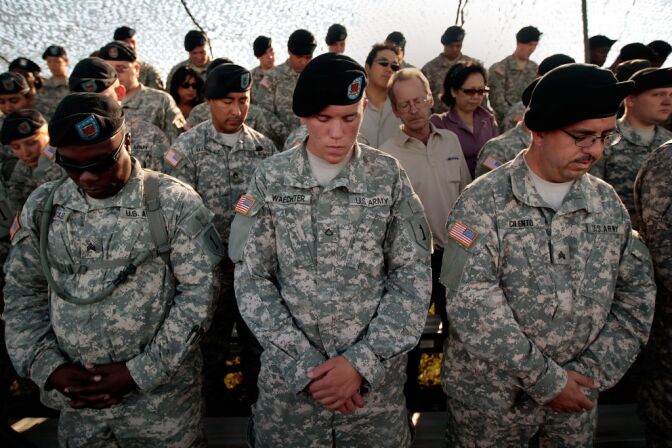 Soldiers with the 1st Infantry Division bow their heads in prayer before a deployment ceremony for another tour in Iraq August 13, 2009 at Fort Riley, Kansas. The Army requires all soldiers take suicide awareness classes as longer and more frequent deployments in Iraq and Afghanistan in recent years have taken a toll. Thousands of soldiers have returned from deployments in Iraq and Afghanistan with Post Traumatic Stress Disorder and other mental difficulties.  