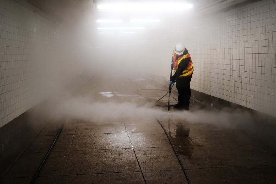 NEW YORK, NEW YORK - MARCH 11: Workers clean a subway station in Brooklyn as New York City confronts the coronavirus outbreak on March 11, 2020 in New York City. President Donald Trump announced on Wednesday evening that he is restricting passenger travel from 26 European nations to the U.S. in an effort to contain the coronavirus which is rapidly spreading throughout the world and America.  (Photo by Spencer Platt/Getty Images)