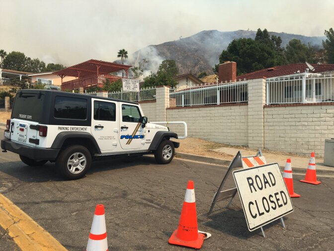 A hillside smolders near Bel Air Drive, which the Burbank Police Department shut down on Saturday, Sep. 2, 2017 during the La Tuna Fire.