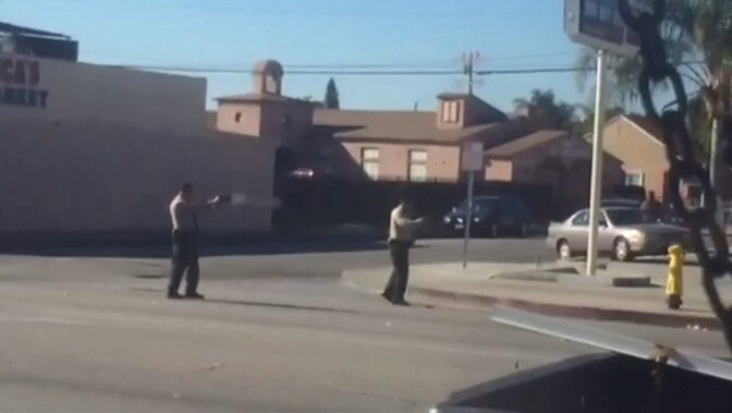 Photo from witness video provided to KTLA, which appears to show Los Angeles County Sheriff's deputies fatally shooting man in Lynwood on Dec. 12, 2015. 
