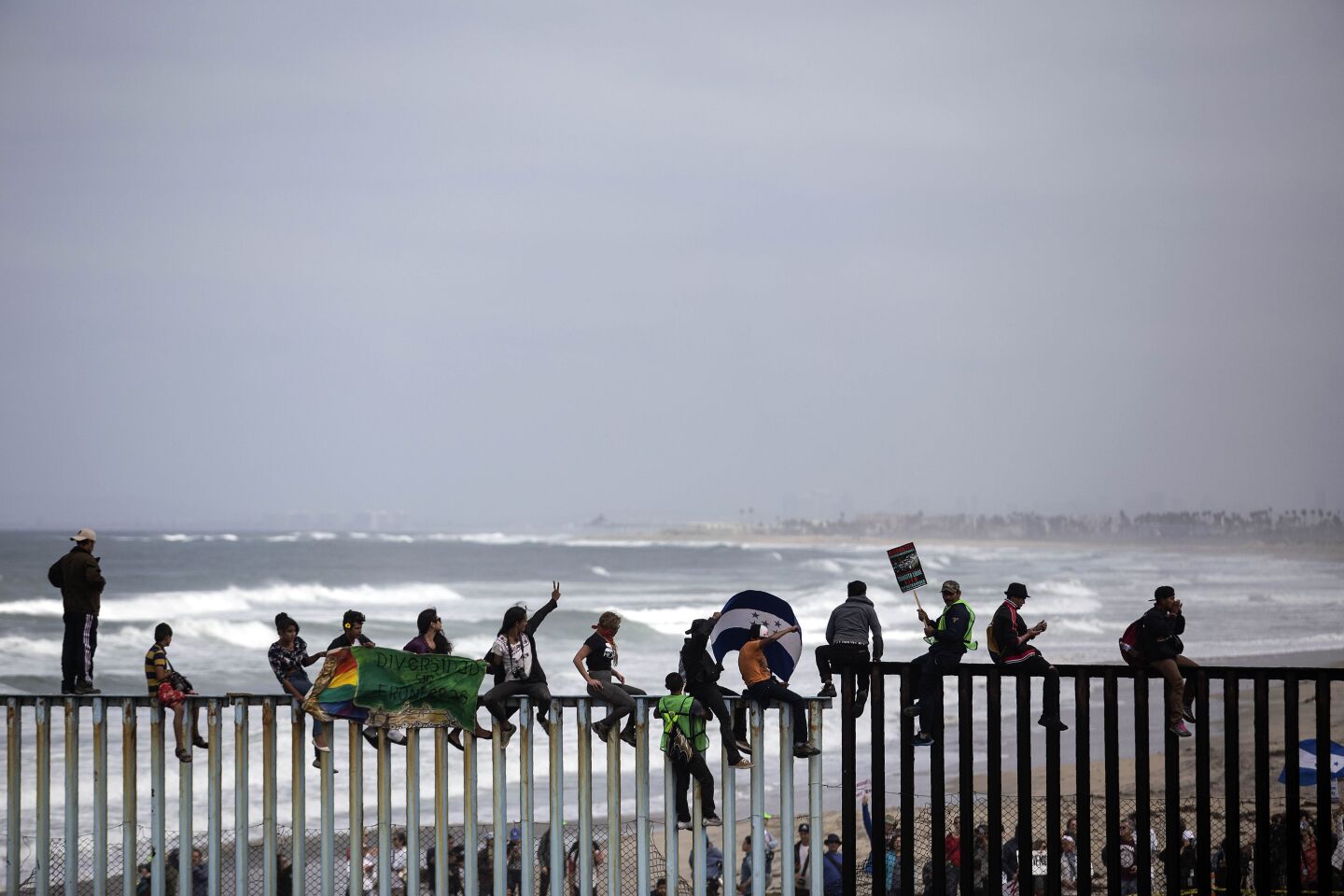 Central American migrants traveling in the "Migrant Via Crucis" caravan demonstrate at the US/Mexico Border at Tijuana's beaches in Mexico, on April 29, 2018