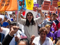 May Day protesters shout slogans calling for immigration reform as they make their way through Downtown Los Angeles.
