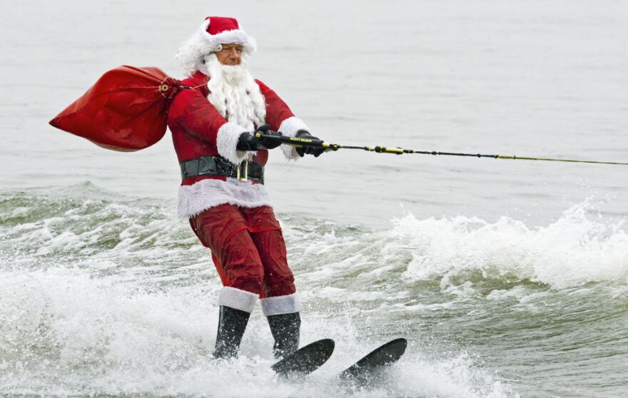 Santa Claus water-skis on Potomac River near Washington, DC, December 24, 2012, at National Harbor in Maryland during th 27th Annual Water Skiing show. This unusual annual event features a water-skiing Santa, flying elves, the Jet-skiing Grinch, and Frosty the Snowman performing on the Potomac River.