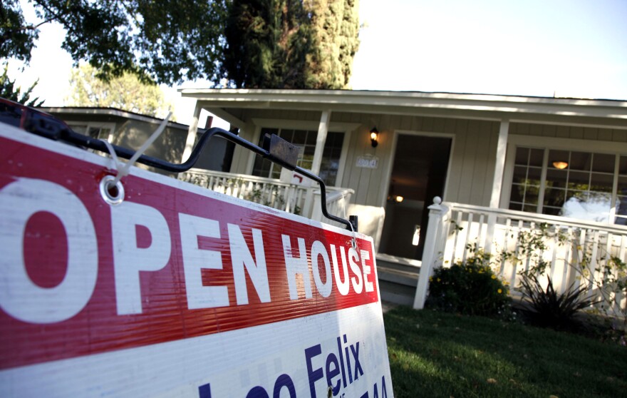 In this Nov. 4, 2010 photo, signs are posted for an open house on the front lawn of a home for sale in Los Angeles. Sales of previously owned homes slipped slightly in October as the housing market struggled in the face of high unemployment and tight credit. (AP Photo/Richard Vogel)