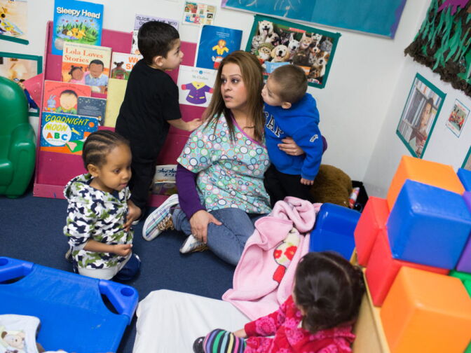 A teacher at Jardín de Niños plays with kids at the school in Lincoln Heights, which receives funding from the California Department of Education. Childcare workers are among the lowest paid professionals in 2014 according to new data from the Economic Policy Institute.