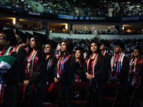 People in graduation cap and gown attire