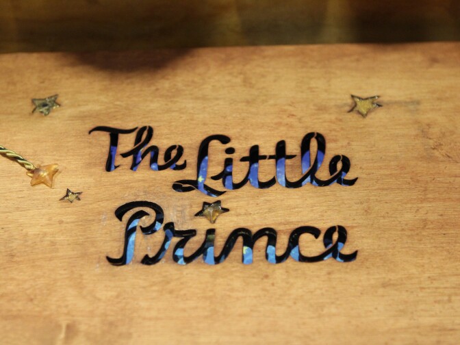 Wooden cover of a book of concept art for "The Little Prince"