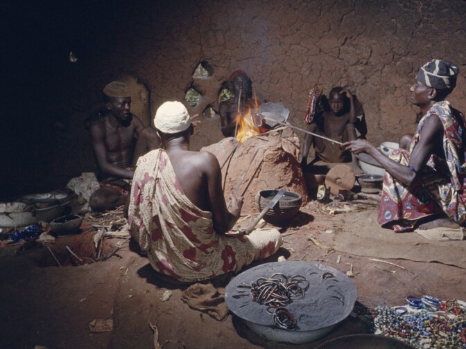 Nupe bead makers around glass-making furnace in 1959, Bida, Nigeria.