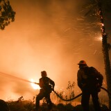 Firefighters battle a wildfire as it burns along a hillside near homes in Santa Paula, California, on December 5, 2017.
Fast-moving, wind-fueled brush fire exploded to about 10,000 acres in Ventura County Monday night, forcing hundreds of people to flee their homes, officials said.  / AFP PHOTO / RINGO CHIU        (Photo credit should read RINGO CHIU/AFP/Getty Images)