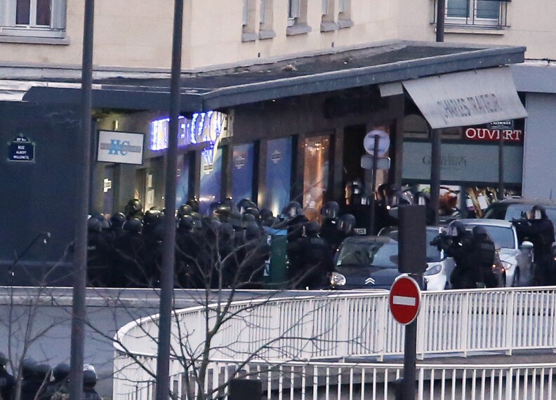 Members of the French police special forces launch the assault at a kosher grocery store in Porte de Vincennes, eastern Paris, where at least two people were shot dead on January 9, 2015 during a hostage-taking drama at a Jewish supermarket in eastern Paris, and five people were being held, official sources told AFP. Several hostages were freed after French commandos stormed a Jewish supermarket in eastern Paris where an assailant was holed up on January 9. After several explosions, police stormed the shop in Portes de Vincennes and everal hostages exited the store shortly afterwards and were taken to safety.   AFP PHOTO / THOMAS SAMSON        (Photo credit should read THOMAS SAMSON/AFP/Getty Images)