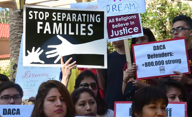 Children hold banners and placards while listening to speakers at a rally outside the 9th Circuit federal court in Pasadena, California on July 16, 2015, where Immigrant rights organizations, labor, and Deferred Action for Childhood Arrivals (DACA) recipients from Arizona and Los Angeles gathered. 