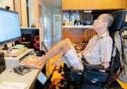 Tim Jin at his computer, using his feet to type.