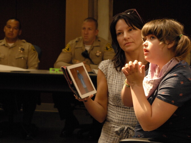 Bobbie Hendrickson brought her 14-year-old daughter Sydney to a Los Angeles County Sheriff’s Department seminar on interactions with the autistic. Sydney, who is autistic, sometimes relies on her computer tablet to communicate with her family. 