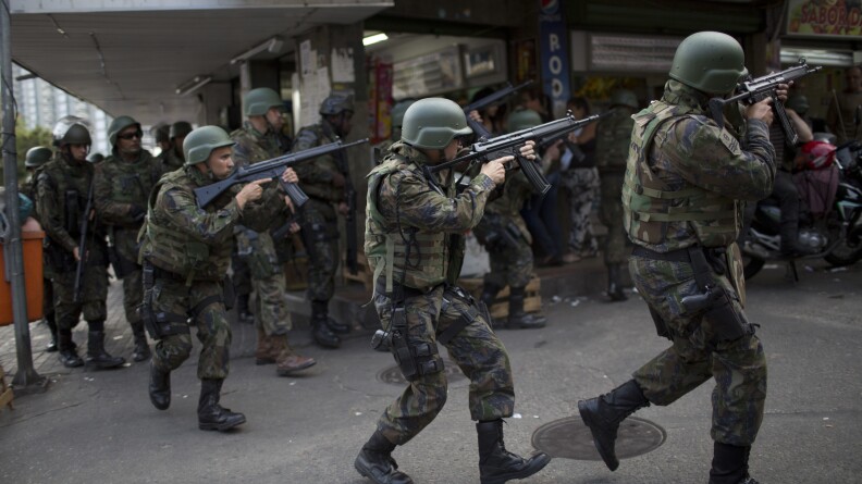 Soldiers enter Rio de Janeiro's Rocinha favela on Friday after shootouts erupted.