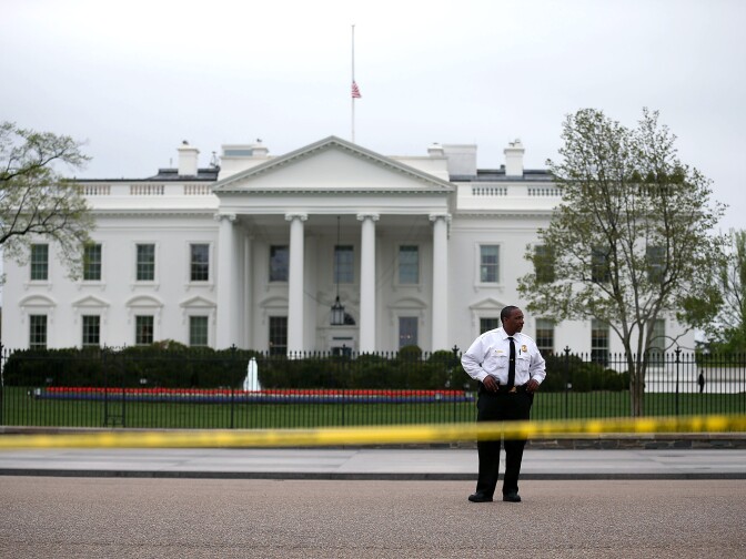 WASHINGTON, DC - APRIL 16: A member of the U.S. Secret Service stands watch on Pennsylvania Ave. in front of the White House after it's flag was lowered to half-staff to honor the victims of the attack on the Boston Marathon, April 16, 2013 in Washington, DC. Police and other law enforcement agencies in Washington and across the country continue to operate at a heightened state of security after yesterday's Boston Marathon bombings that killed three people injured hundreds.  (Photo by Mark Wilson/Getty Images)