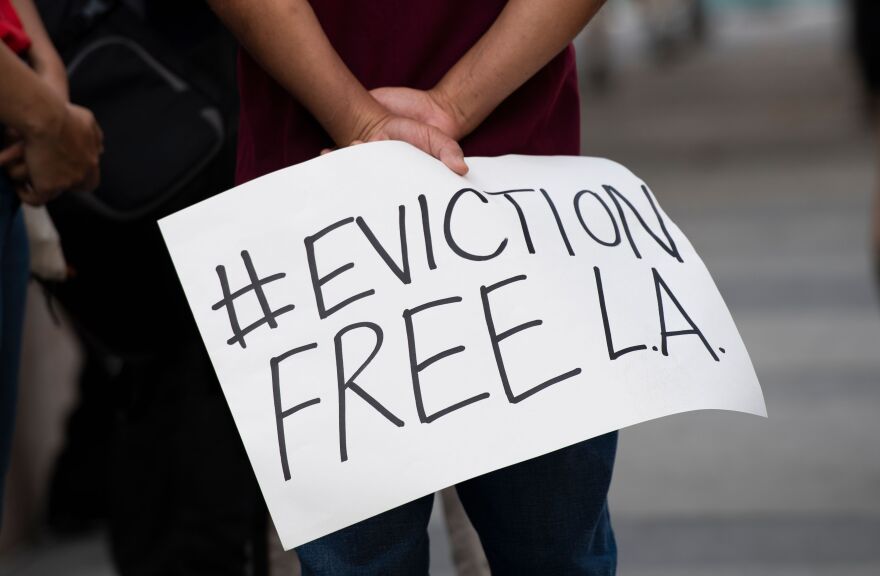 Renters and housing advocates attend a protest to cancel rent and avoid evictions amid Coronavirus pandemic on August 21, 2020, in Los Angeles, California. (Photo by VALERIE MACON / AFP) (Photo by VALERIE MACON/AFP via Getty Images)