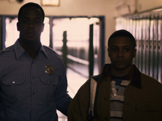 Still from film’s reenactment of Darius Monroe being brought to face authorities