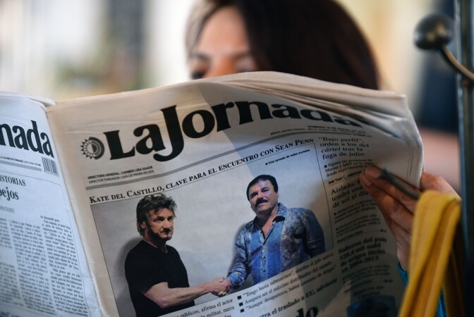 TOPSHOT - A woman reads La Jornada newspaper in Mexico City, on January 10, 2016 which shows a picture of drug lord Joaquin Guzman, aka "El Chapo" (R), shaking hands with US actor Sean Penn. The Hollywood-worthy recapture of "El Chapo" took a stunning turn Sunday as authorities sought to question Penn over his interview with the Mexican drug kingpin. A federal official told AFP that the attorney general's office wants to talk with Penn and Mexican actress Kate del Castillo about their secretive meeting with Guzman in October, three months before his capture on January 8.   AFP PHOTO / ALFREDO ESTRELLA / AFP / ALFREDO ESTRELLA        (Photo credit should read ALFREDO ESTRELLA/AFP/Getty Images)