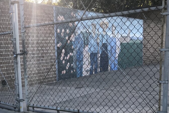 Some of Vásquez's murals are difficult to view up close, like this one inside the gate at the Memorial Park pool in Santa Ana. Titled "Chicano Gothic" (1987), the photo depicts the life of working-class Mexican-Americans in Orange County. The title and theme are a reference to Grant Wood's 1930 painting "American Gothic."