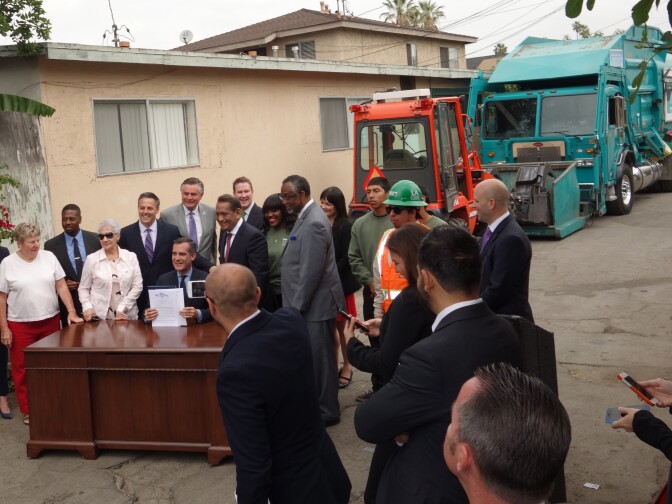 Los Angeles Mayor Eric Garcetti shows an order he signed April 23, 2015 directing the Bureau of Sanitation to develop a plan to recruit hundreds of volunteers to monitor streets.  His $9 million Clean Streets Initiative, which still must be approved by the City Council, would also create three quick cleanup teams, and five inspectors to roam the city grading its cleanliness. 