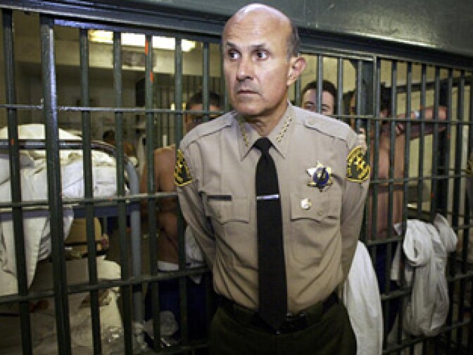Overcrowding at the Los Angeles County Jails has been an issue for years. In this photo, Sheriff Lee Baca talks with reporters as he leads a tour inside the Men's Central Jail at the Twin Towers Correctional Facility in Los Angeles, Wednesday, May 19, 2004. At that time, he faced criticism over a spate of deaths in the country's largest jail.