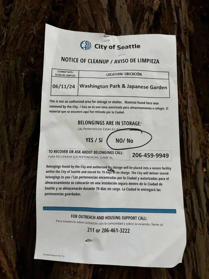 A sign in the city of seattle notice of a cleanup for homeless encampments