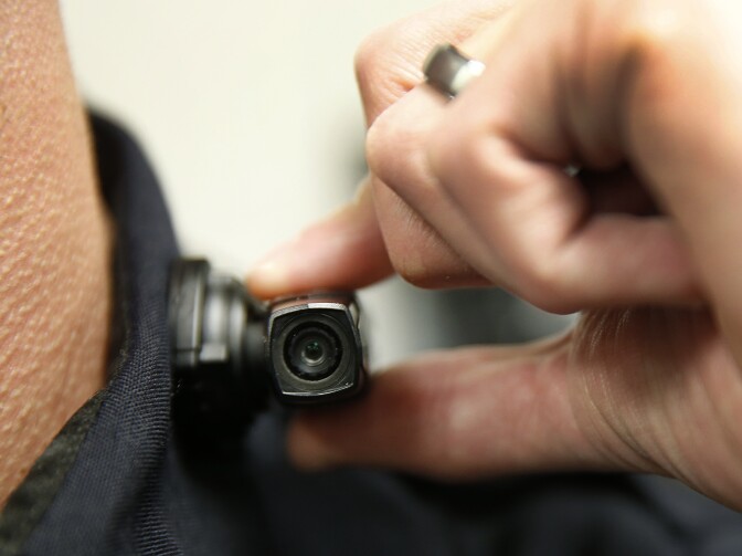 WEST VALLEY CITY, UT - MARCH 2: A West Valley City police officer shows off a newly-deployed body camera attached to his shirt collar on March 2, 2015 in West Valley City, Utah. West Valley City Police Department has issued 190 Taser Axon Flex body cameras for all it's sworn officers to wear starting today.  (Photo by George Frey/Getty Images)
