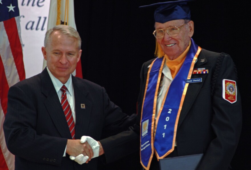 Claude Chastain Jr. of Hemet (R) who served in the U.S. Navy during World War II receives his high school diploma from Riverside County Superintendent of Schools Kenneth M. Young at the annual Operation Recognition ceremony in Moreno Valley.