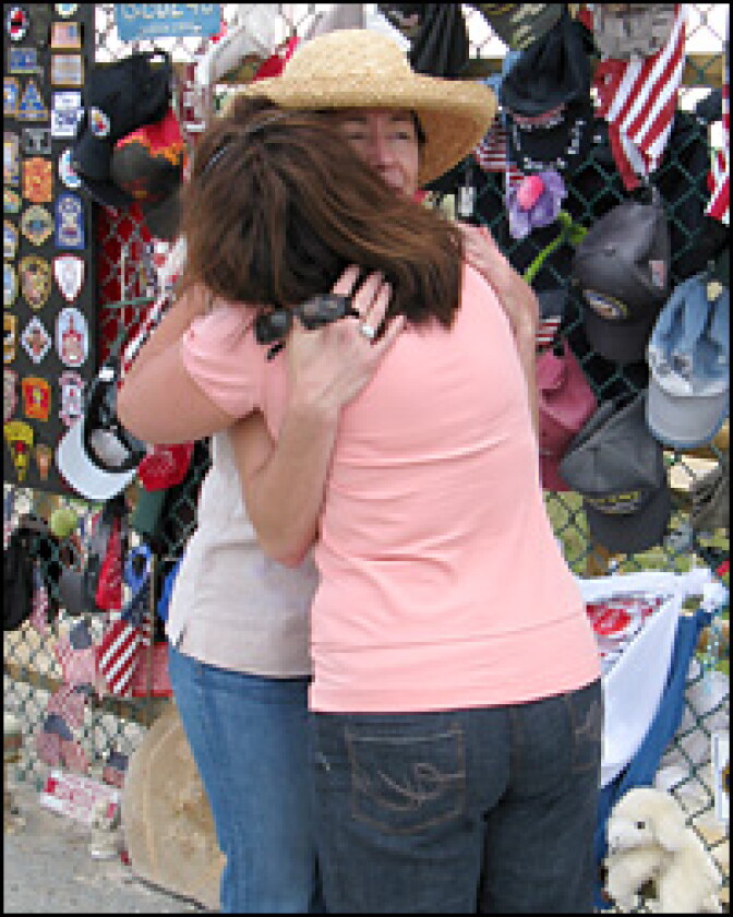 Deborah Borza (left) hugs a visitor at the temporary memorial for Flight 93 in Shanksville, Pa. Borza's daughter, Deora Bodley, was a passenger on the flight.