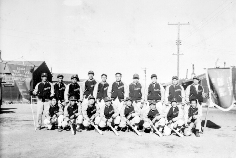 The Japanese American Tule Lake baseball champions 1944 stand and kneel in two rows for picture, during WWII incarceration.