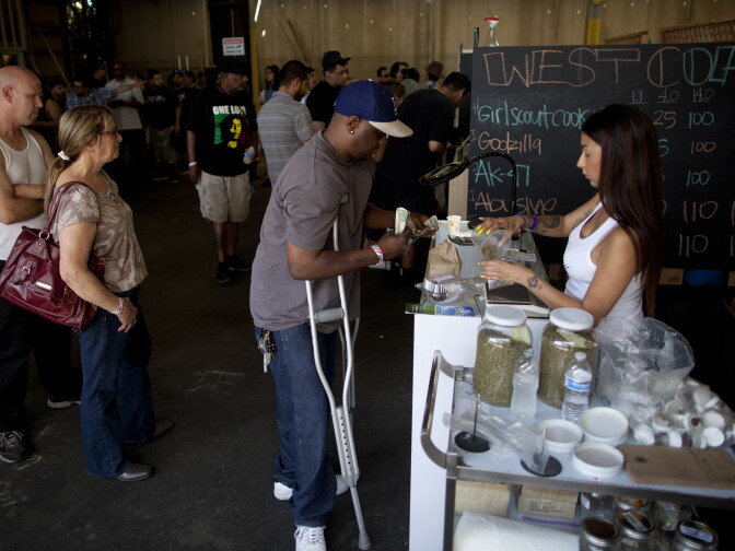Medical Marijuana patients line up at one of the booths to purchase cannabis during the first ever farmers market for pot producers at the California Heritage Market in Boyle Heights. The event was billed as an opportunity to connect consumers with producers directly.