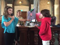 Emma Allison, a fourth grader at Los Feliz Charter School for the Arts, presents her group's model that would reuse kitchen waste water for plants. 