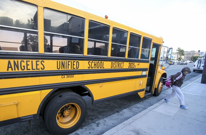 Students arrive at a school in Los Angeles on December 16, 2015. Responding to a threat emailed to school board members, all Los Angeles Unified School District campuses were closed on December 15 and authorities conducted an exhaustive search of more than 1,500 school sites, but the threat was found not to be credible. AFP PHOTO/RINGO CHIU / AFP / RINGO CHIU        (Photo credit should read RINGO CHIU/AFP/Getty Images)