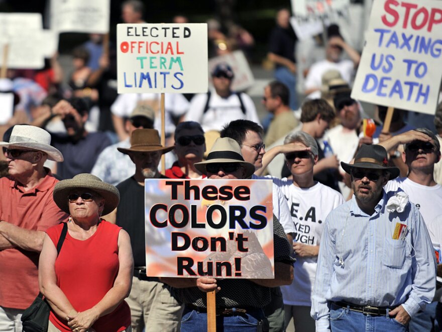 Participants hold up signs at a Tea Party protest at the Oregon State Capitol in September. Historian Michael Kazin says the Tea Party movement is a problem for Democrats and for Republicans, too, who have to channel the discontent to their benefit and not be consumed by it.