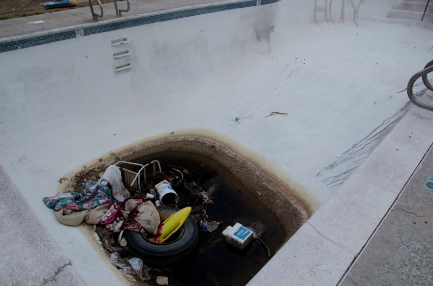 Trash at the bottom of an empty pool in Baker, Calif., Thursday, November 9, 2012.