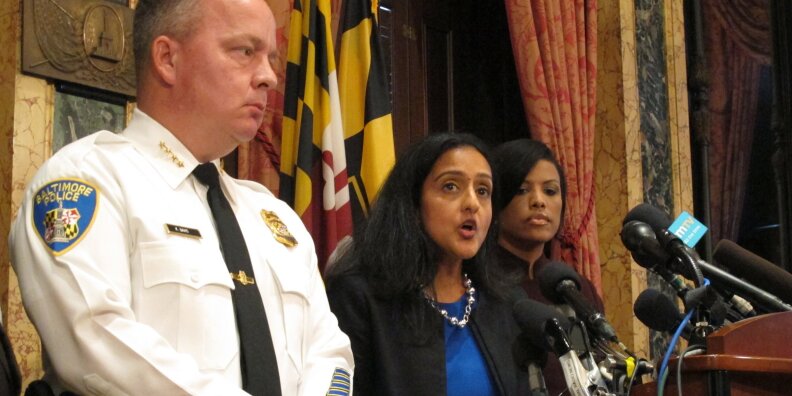 Vanita Gupta, head of the Justice Department's Civil Rights Division, discusses the department's findings on the investigation into the Baltimore City Police Department as Police Commissioner Kevin Davis, left, and Mayor Stephanie Rawlings-Blake, right, listen on August 10, 2016, at City Hall in Baltimore. Associated Press/Brian Witte
