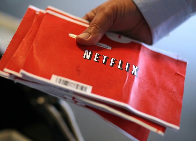 SAN FRANCISCO, CA - OCTOBER 24:  A U.S. Postal worker holds a stack of Netflix envelopes at the U.S. Post Office sort facility on October 24, 2011 in San Francisco, California.  Online movie rental company Netflix reported third quarter earnings of $62.5 million, or $1.16, per share compared to $38 million, or 70 cents per share one year ago.  (Photo by Justin Sullivan/Getty Images)