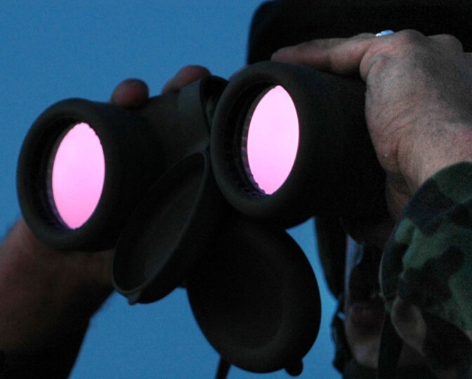 U.S. Army Pfc. Holt Duggins, from the North Carolina Army National Guard, looks through his binoculars at an area of the Mexican border in San Luis, Ariz., July 26, 2006. National Guard Soldiers are working with the U.S. Border Patrol in support of Operation Jump Start. (U.S. Air force photo by Tech. Sgt. Brian E. Christiansen) (Released)