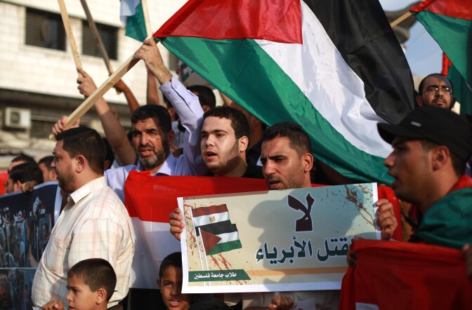 Palestinian supporters of ousted Egyptian president Mohamed Morsi protest against the violence in the Egyptian capital on August 14, 2013, in Gaza City. 