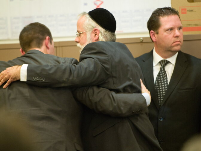 Former Fullerton police Cpl. Jay Cicinelli, at right, looks back into the court gallery as his attorney Michael Schwartz, center, embraces co-counsel after the not-guilty verdict is read in the murder trial of Kelly Thomas Monday in Santa Ana, Ca.
POOL PHOTO, MINDY SCHAUER, ORANGE COUNTY REGISTER