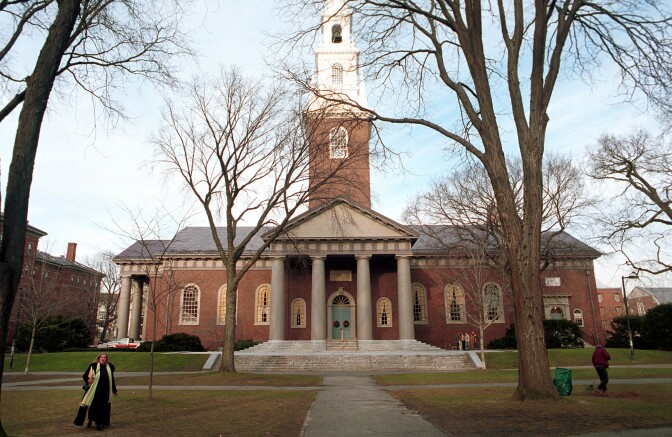People walk around the Harvard University''s main campus in Cambridge, MA.