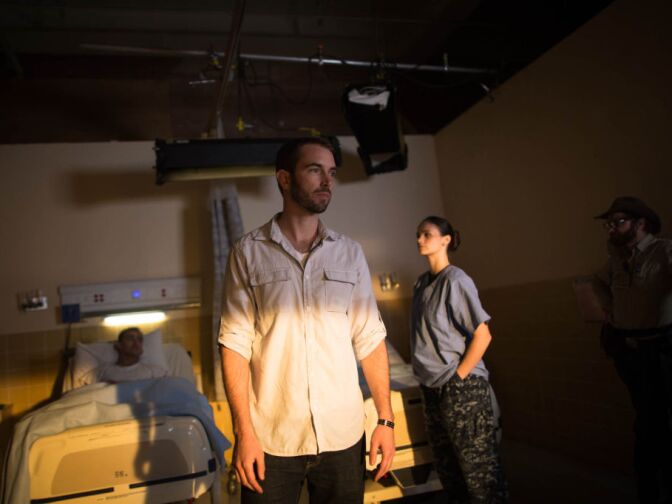 Kyle Hausmann-Stokes examines the lighting of a set for a public service announcement targeted at veterans.