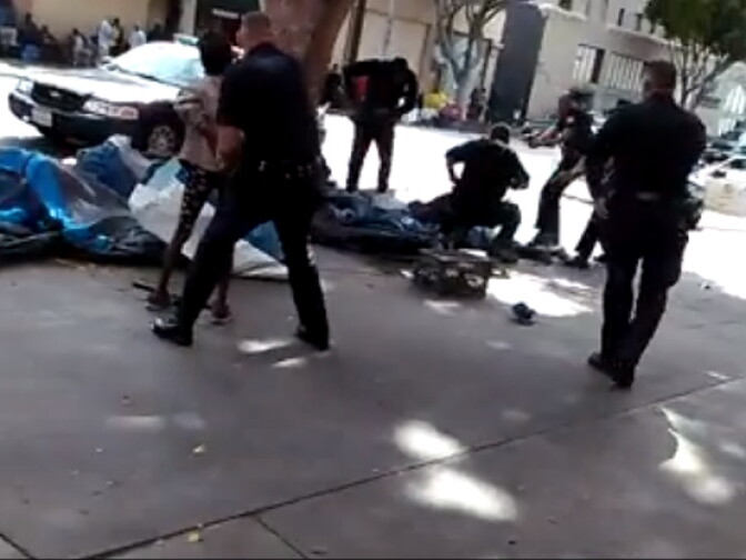 A screenshot of a video posted on Facebook shows at least five officers responding to a situation in Skid Row and shooting a man. 